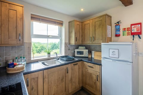 kitchen with fridge freezer, microwave