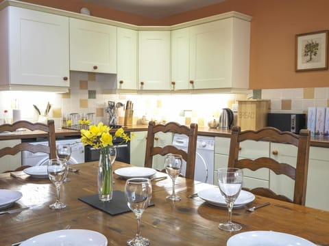 Y Beudy kitchen dining area. Kitchen table laid for dinner