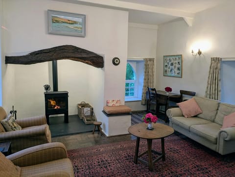 Living room with an inglenook fireplace and log burner