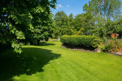 Large lawns and mature trees and flower beds
