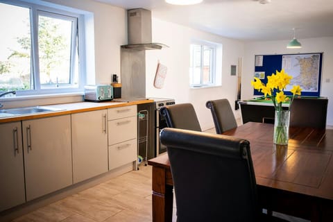 Kitchen diner with table and chairs and games area with pool table