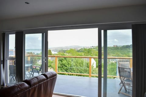 Large doors leading from sitting room to balcony with views of the harbour