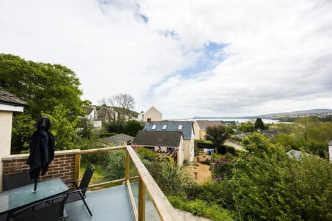 Outdoor table and chairs on the balcony with views looking over neighbouring properties.