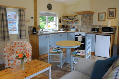 Kitchen with table and chairs and armchair with coffee table