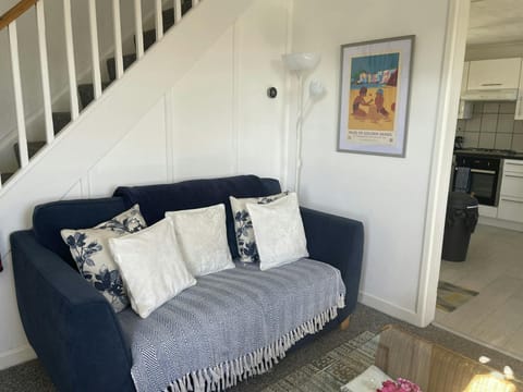 Sitting room with sofa and stairs leading to the first floor