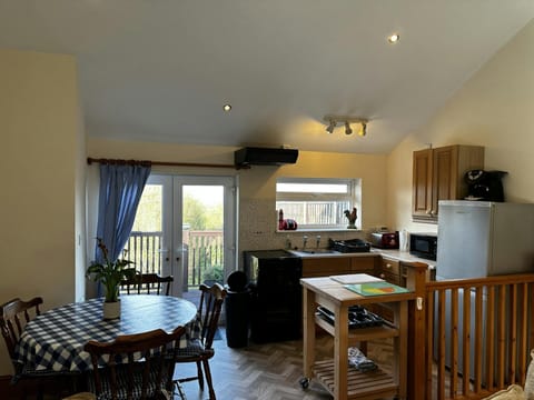 Living area, with table and chairs, and kitchen area