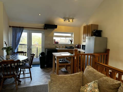 Living area, with table and chairs, sofa and TV
