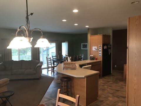 Open concept kitchen, dining and living room on top floor