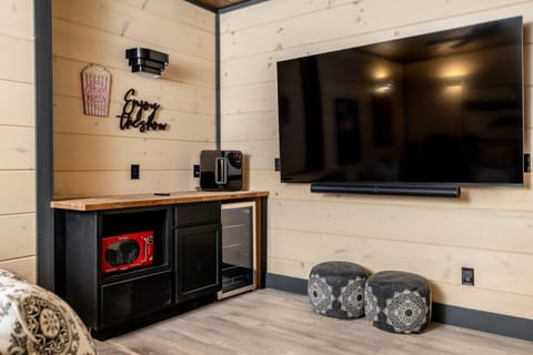 With a conveniently placed mini-fridge and microwave, you'll have everything at your fingertips for the perfect movie night after a long day hiking in the Smoky Mountains.