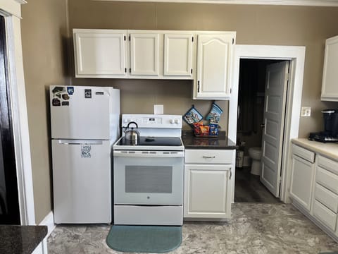 Kitchen has a new stove and dishwasher