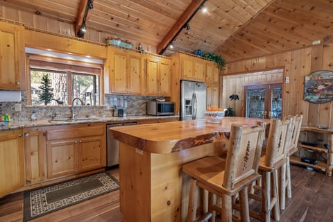 Kitchen - The kitchen is fully equipped w/granite countertops, stainless steel appliances, & a custom wood-top island w/seating.