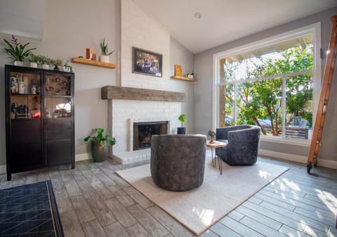 The inviting living room is great for reading, relaxing or having a drink. The library, gas  fireplace, comfortable chairs and large window that brings the  light in, make this one of the best rooms in the house. 