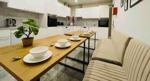 Fully equipped shared kitchen with ample seating, perfect for cooking and dining together with other guests.