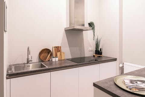 Bright and cozy bedroom featuring large windows with natural light, offering a comfortable and stylish space for a peaceful rest.