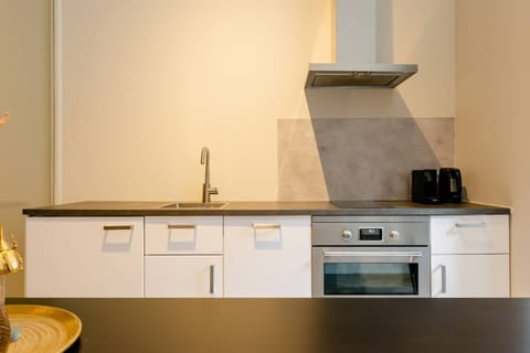 A modern kitchen with clean lines and essential appliances, providing a functional and stylish space for cooking.