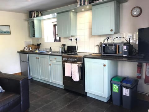 Kitchen with electric cooker, microwave and toaster