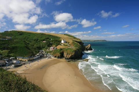 View from high above Llangrannog beach with village and houses to left sea to the right
