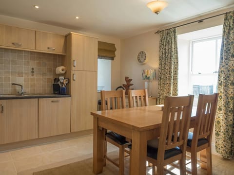 Kitchen dining area at St Brides View with table, 4 chairs, fitted units and window