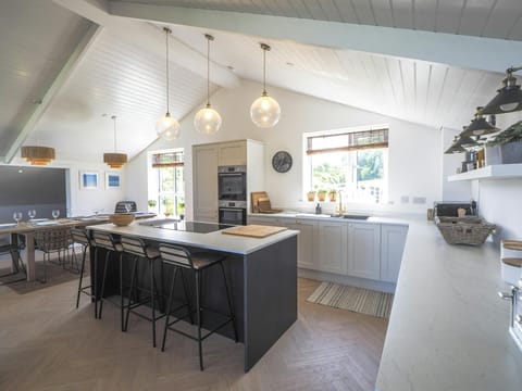 Kitchen with island unit and stools