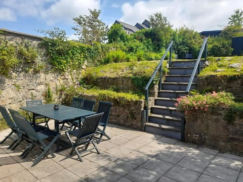 Patio area with step leading to the garden