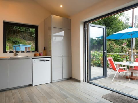 Kitchen with patio doors opening onto terrace with picnic table