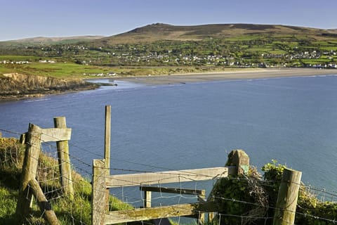 View of Newport bay looking across the sea to the and beach with hills in the distance