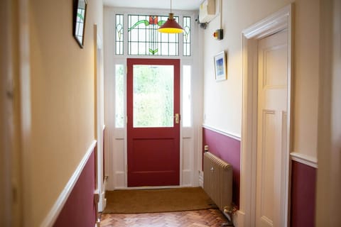 Stained glass fan lights above front door. Parquet flooring