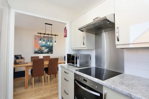 Fully equipped kitchen area on first floor leading onto dining area