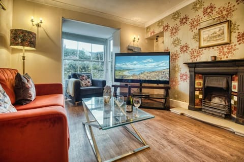 Sofa, large TV, ornamental fire place, armchair, coffee table