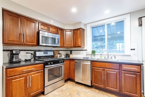 Fully equipped kitchen with modern appliances, including a stove, oven, refrigerator, microwave, and all the cookware and utensils you need to prepare your favorite meals.