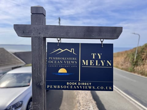 Ty Melyn Roadside Sign & Pembrokeshire Ocean view Logo