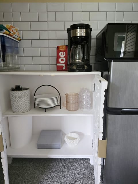 Fridge, microwave, coffee/tea maker, cookware/dishes/utensils