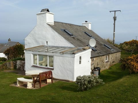 Tal y Gaer from the garden showing lawns and patio area with seating