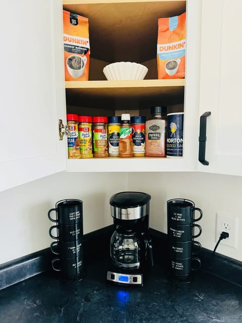 Seasonings, Coffee & filters and Sugar is in the cabinet above the Coffee maker