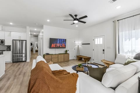 Cozy up on the couch for your favorite show in a 65“ smart TV after a long day at the beach.