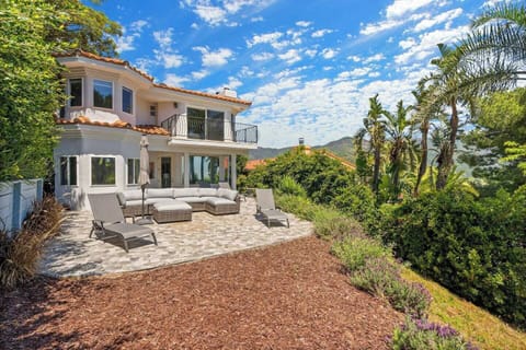 Spacious patio with outdoor seating and beautiful hillside views.