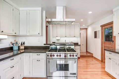 Chef's kitchen (w/ 6-burner Wolf range) offers an inviting space for meal prep!