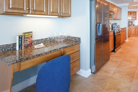 This workspace with a blue chair is featured in the kitchen area and complimentary WiFi is included during your stay