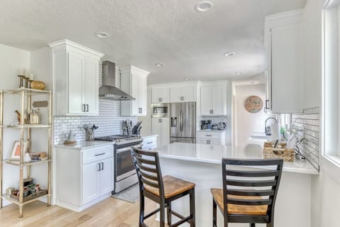 Cook up a storm in this bright, white kitchen! Modern appliances and a stylish island make meal prep a breeze.