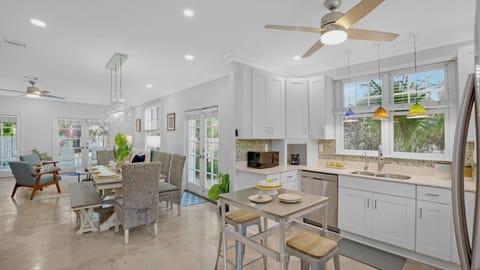 The living room, dining room, and kitchen flow as one space...