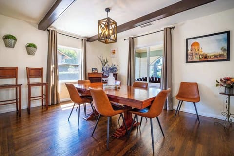 Dining Room: Gather 'round the stylish wooden table, brightened by natural light and chic decor!