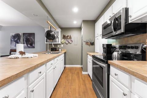 Full size kitchen featuring stainless steel appliances.