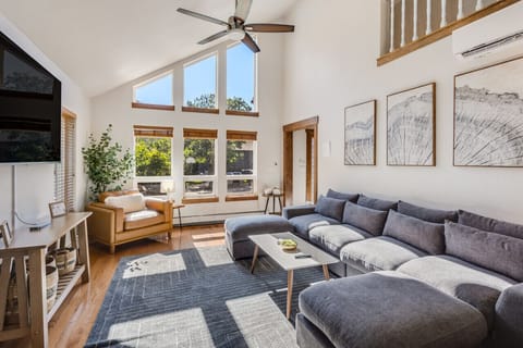 Living room with plenty of comfortable seating and 75" TV