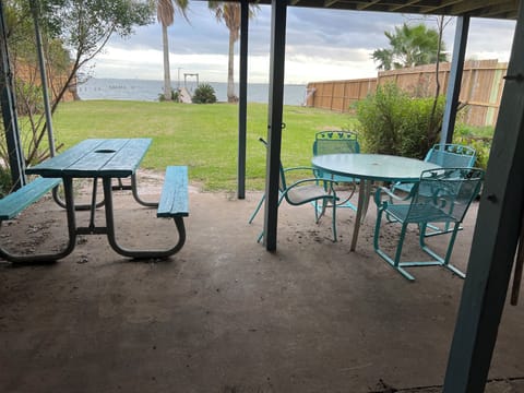 Outside sitting area includes picnic table table and four chairs and patio bar