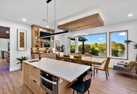 Start your mornings with a serene lake view and a cup of coffee in this modern-meets-nature kitchen.