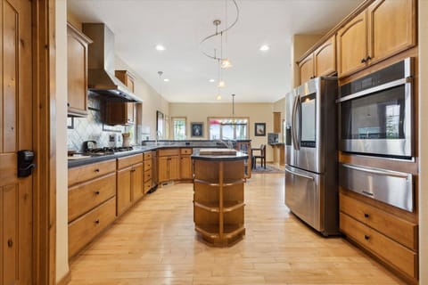 Large kitchen with middle island and stainless steel appliances
