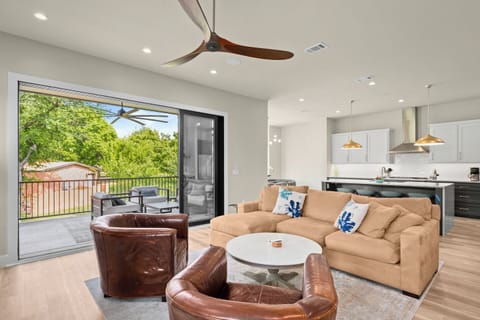 Living room, back towards kitchen and dining.  Fully open balcony doors!