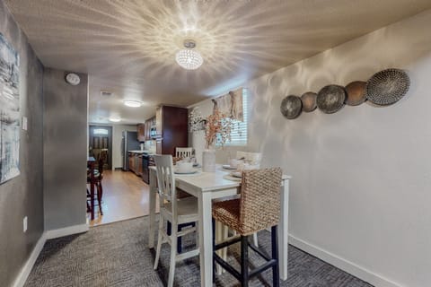 This dinning room has a table with seating for four and one extra chair