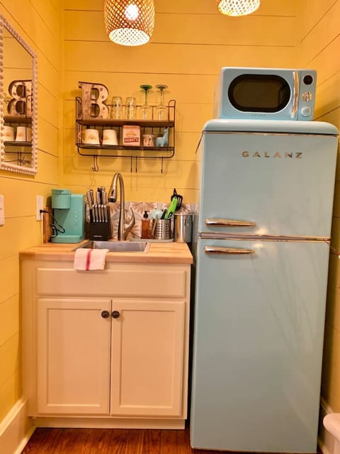 Fridge, microwave, coffee/tea maker, cookware/dishes/utensils