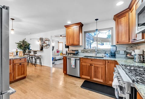 Kitchen, all Open to the Dining Room & Sunroom Room; Professional Grade Kitchen Stainless Appliances, View of Pool & Lake Arbor from Window.